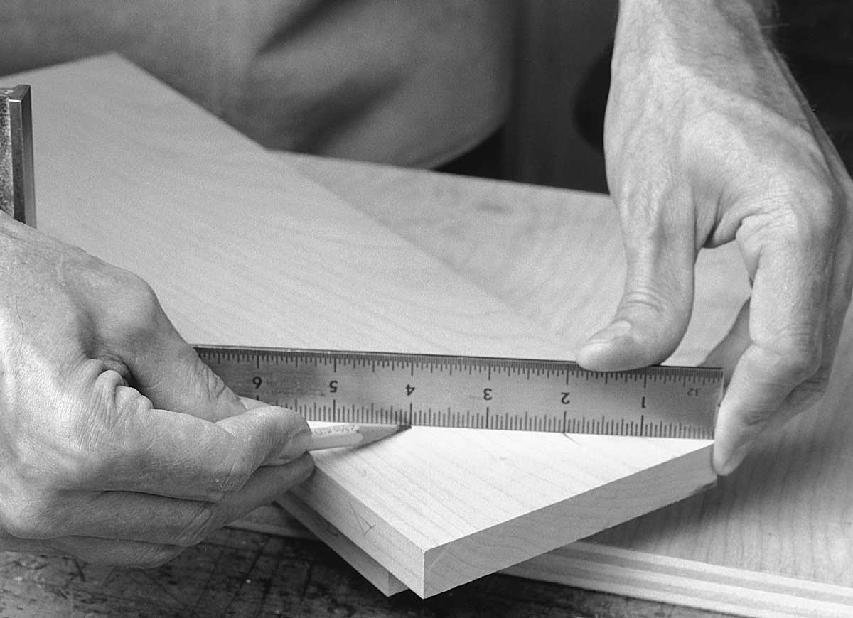 Mark pins and half pins on the end of the board. You can space them by eye, or use a ruler for more consistent spacing. A pencil mark is plenty accurate at this stage, because the pins are first parts of the joint to be cut. 