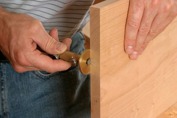 First use a marking gauge to mark the rabbet width and depth