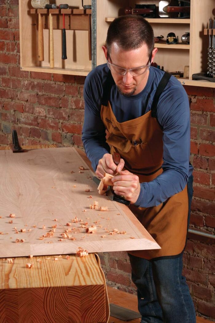 Then use a jack plane or jointer plane to complete the bevel, working down to your layout lines