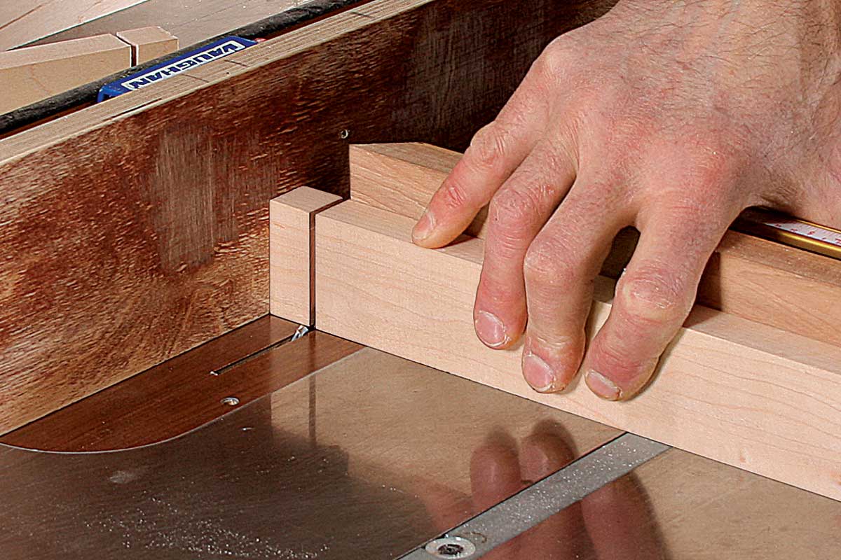 Top and bottom, too. To cut the top and bottom shoulders, keep the fence in the same position. Adjust the blade so it’s about 1⁄32 in. from the base of the tenon. 