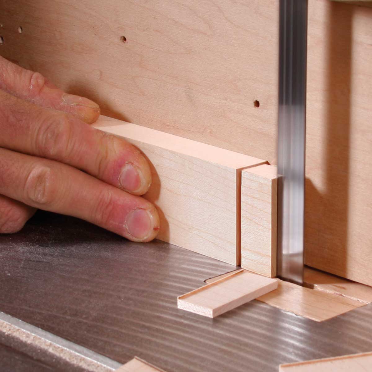 Close shave. Zip off most of the waste using the bandsaw. Be sure to use a fence, and aim to leave the tenon about 1⁄16 in. over final thickness.