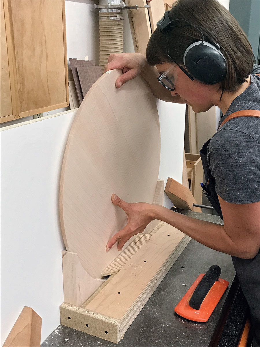 <strong>Cut an underbevel. </strong>With access to a shaper, Martin cut the bevel by angling a straight cutter and using a high fence and a shopmade jig to hold the tabletop.