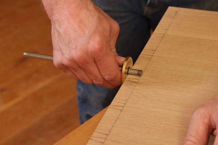 After the tails are laid out, I use the marking gauge to scribe sections of the baseline on the exterior only where waste will be removed.