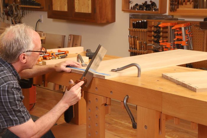 Due to the mitered nature of this joint, the pin cuts are made on a 45° angle. Because of the height of the board, I find it awkward sawing it upright, so I leave it flat on my benchtop to make the 45° cuts.