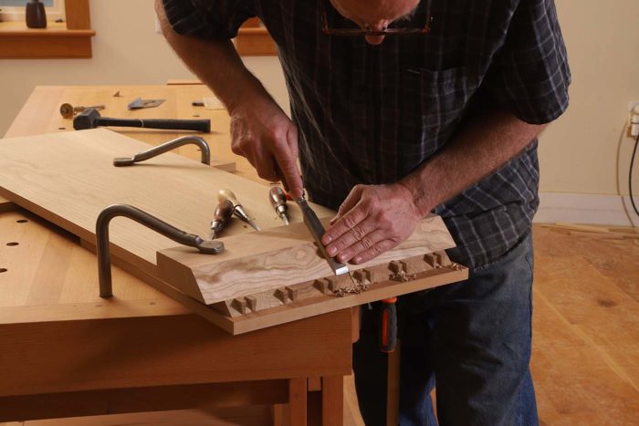 I find here many small cuts are more effective than large ones. I start the process with a 1/4-in. chisel and make a couple of cuts from the baseline to the miter’s edge.