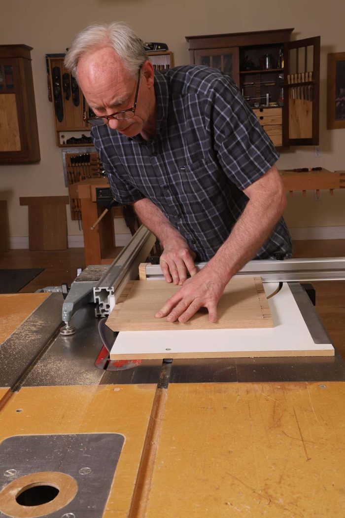 After paring the miter on the pin board, all that remains is to cut the mating miter on the tail board. I do this on the tablesaw with a crosscut sled. I tilt the blade to 45° and slide my Unifence to the front of the saw table and use it as a stop.