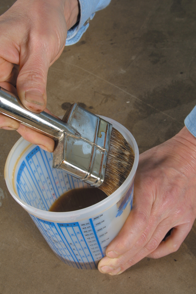 Condition the bristles of the brush as described in the preceding essay, then dip the bristles to about half of their total length into a container filled with the finish. Gently squeeze off the excess against the sides of the container (A).