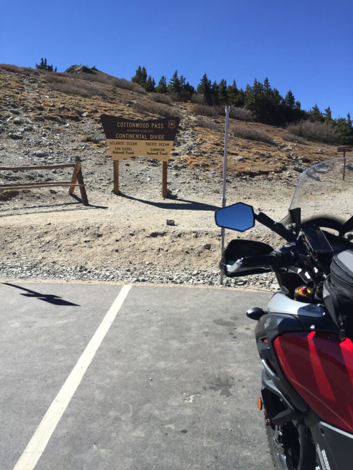 Motorcycl parked by park sign