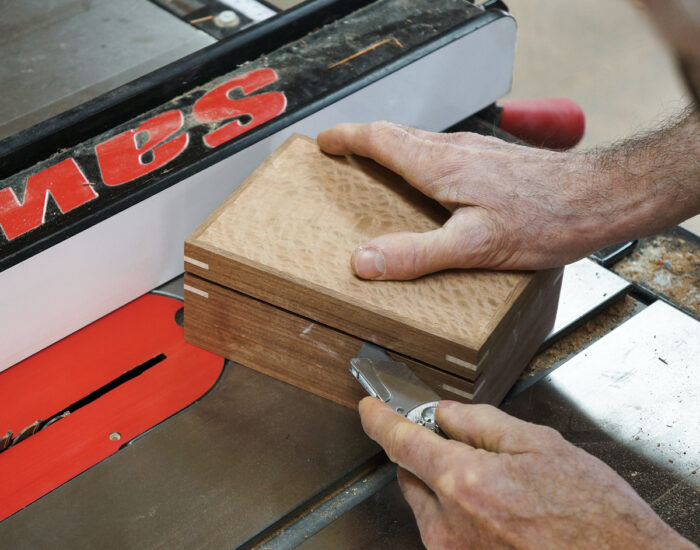 Testing the cut for the box lid with a knife for structure