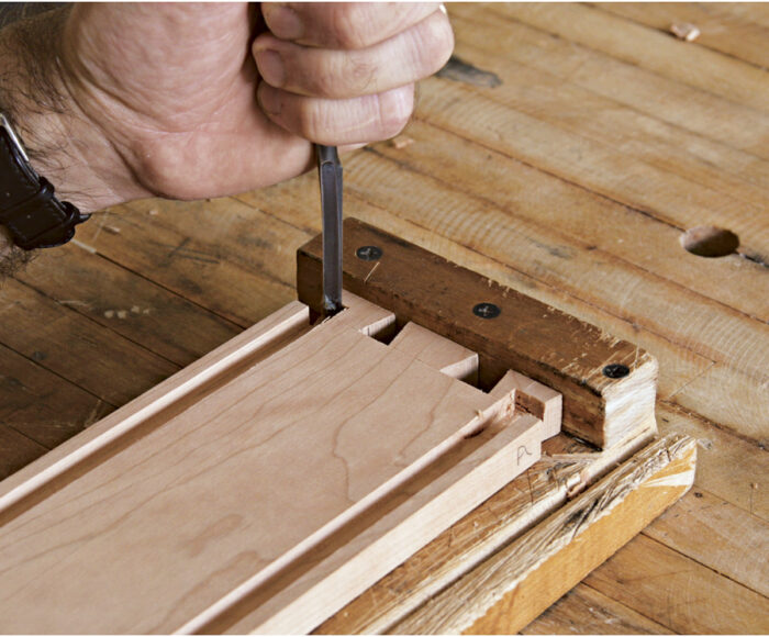 Round the ends of the grooves where the router cannot reach.