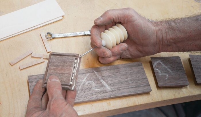 Applying glue to the grooves and surface of miter joints