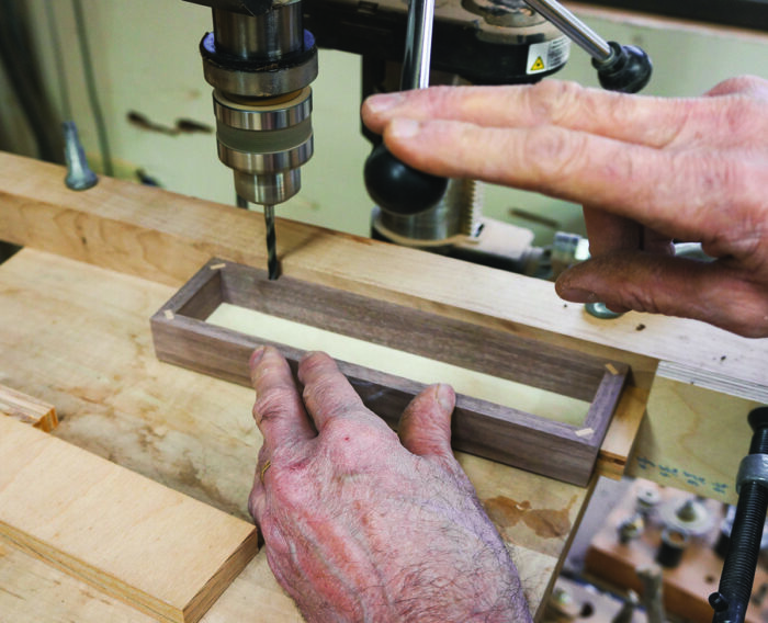 Drill the 5mm holes with the box against one stop block and then the other. Note that the spacer block is required in each position