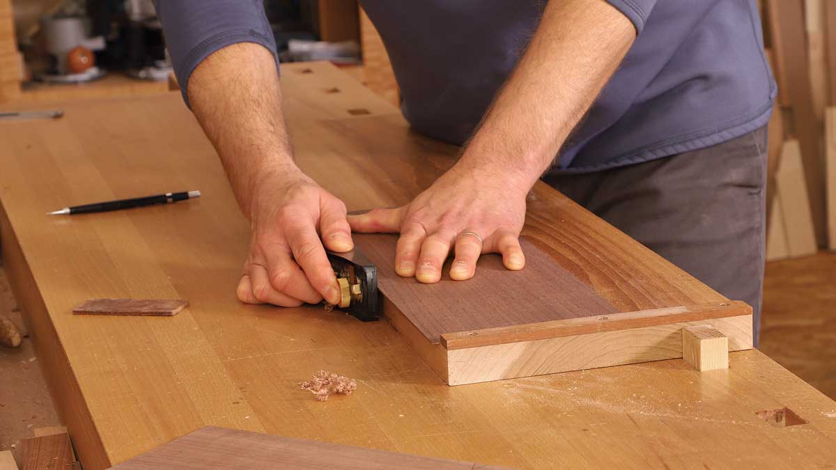 Block plane a glue joint. With a thick sheet of shopsawn veneer elevated on a planing stop, Korsak joints the edge with a few swipes of his block plane.