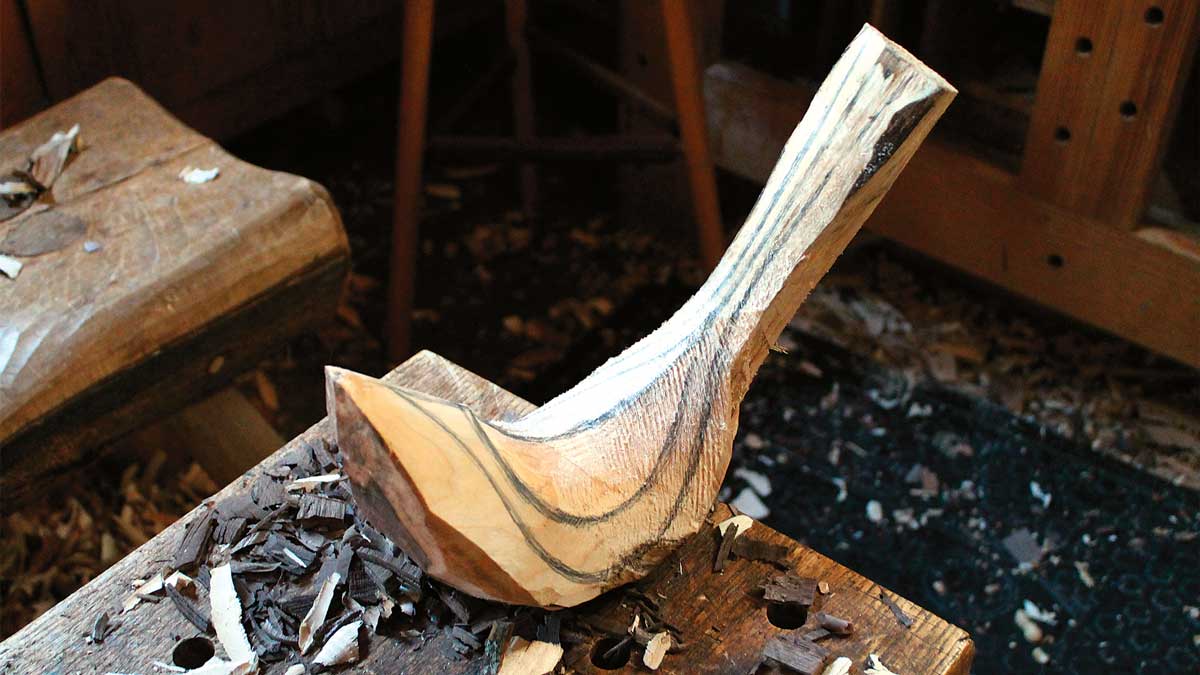 tree branch carved into bird sanded