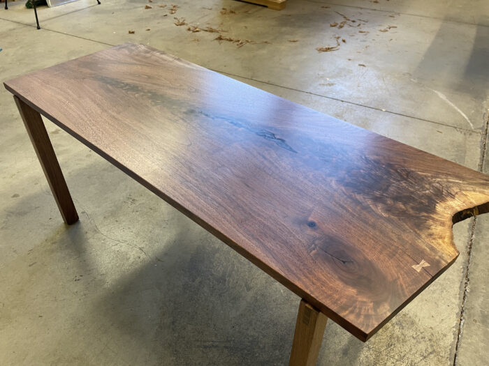 The finished product of a coffee table derived from a slab of walnut.