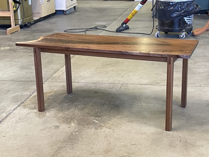 The finished product of a coffee table derived from a slab of walnut.