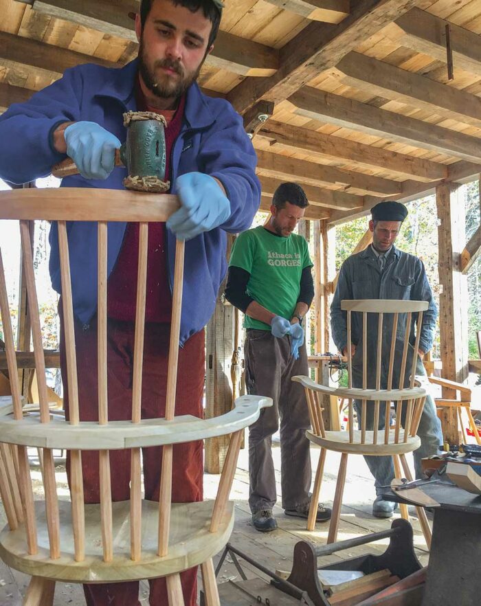 class working on chairs with mallets