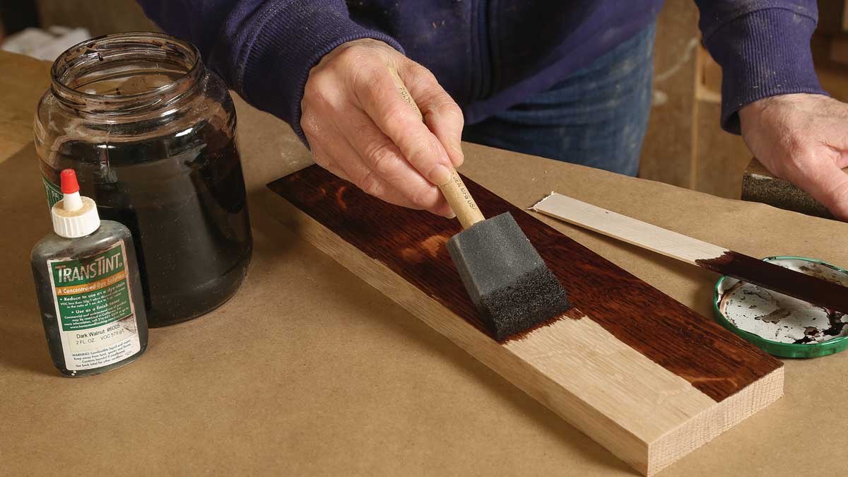 Brush on a base color. Hiller uses TransTint waterborne dye in Dark Walnut #6005. Apply the solution with a foam brush, then use a dampened cloth to spread it evenly on all parts of the piece. Wipe off the excess with a dry cloth. When the dye is dry, check the surface. If it feels rough, carefully scuff-sand with 320-grit paper.