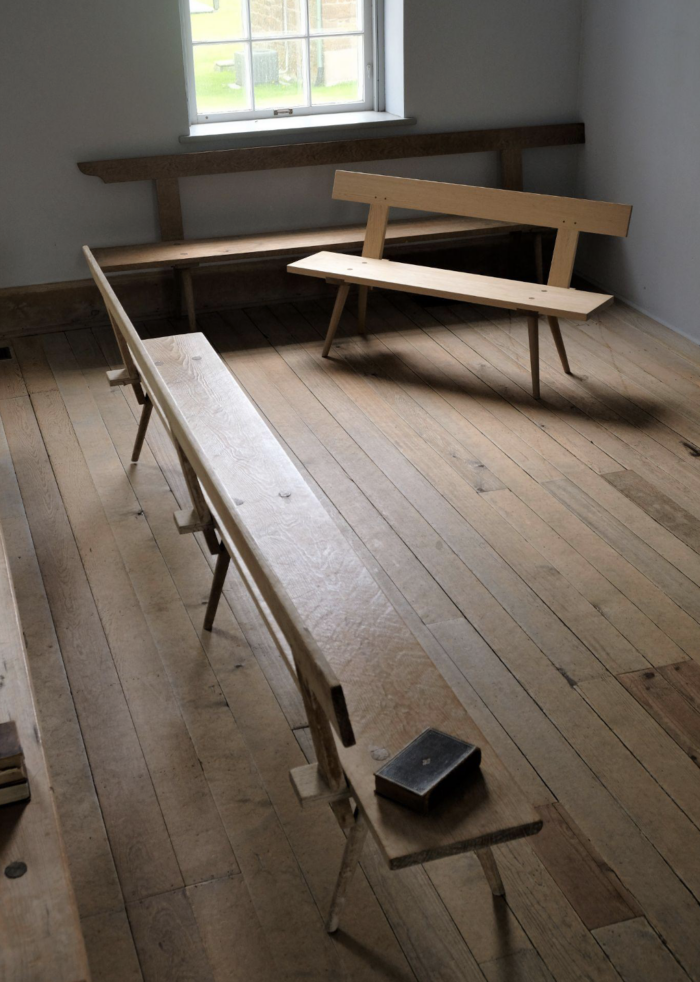 A new Amana Church Bench, built by Jameel Abraham, and an older one.