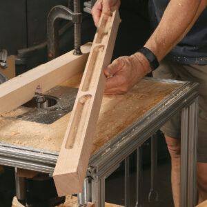 Recess time. Before assembling the cart frame, Boggs routs recesses into the top long rails. They will hold pencils, drill bits, earplugs, and other small items while still allowing boards to be placed across the rails.