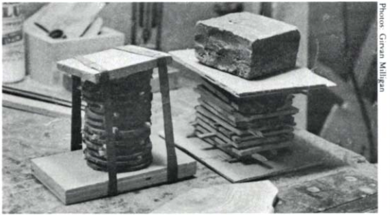 stacks of end grain segments, cut from branches, secured together with clamping cauls and inner tubes for clamping pressure. 