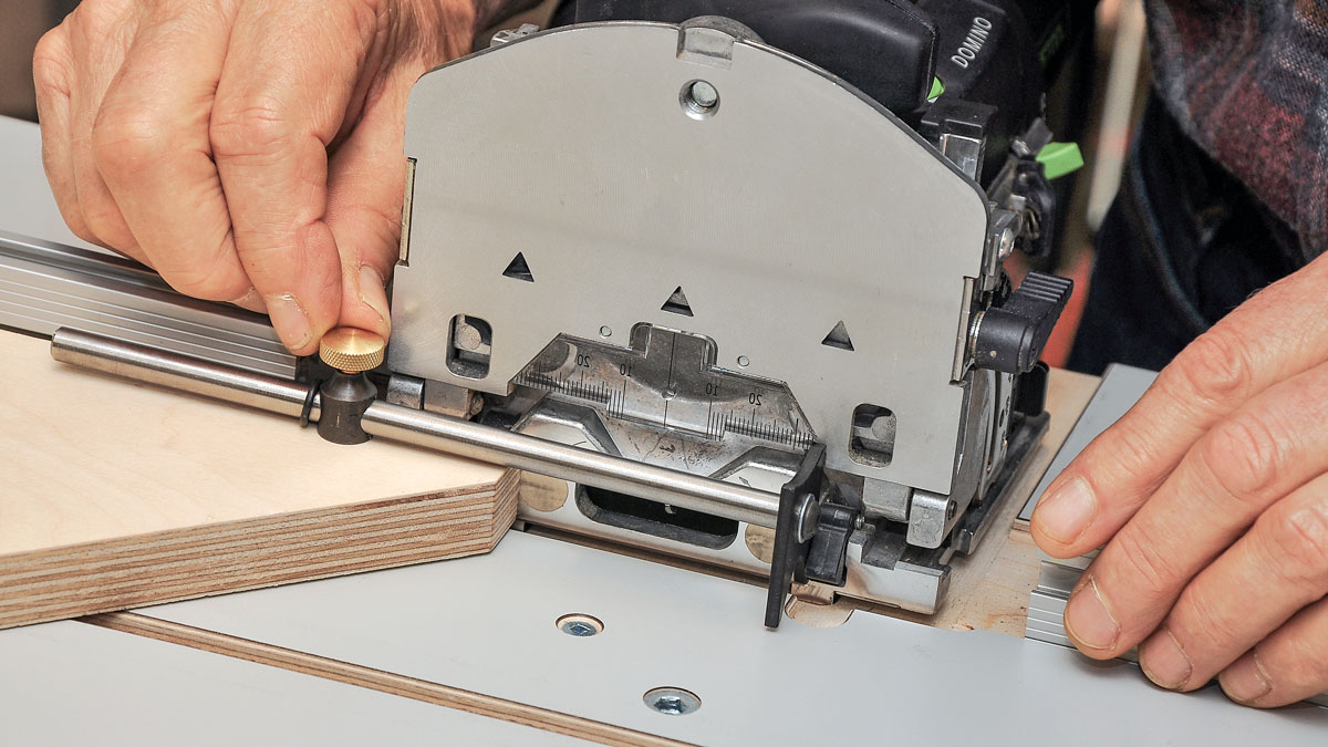 Slick setup gauge. The table includes a gauge that bumps up against the spring-loaded stops on the Domino so you can accurately reverse the plywood fence from one side to the other.