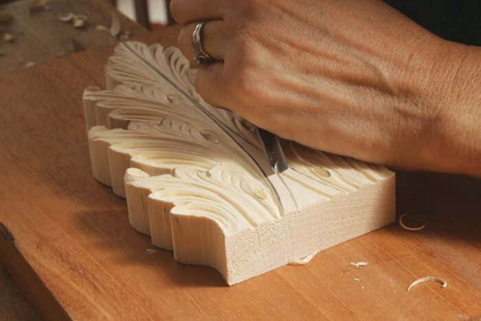 Mary carves the base of the leaf.