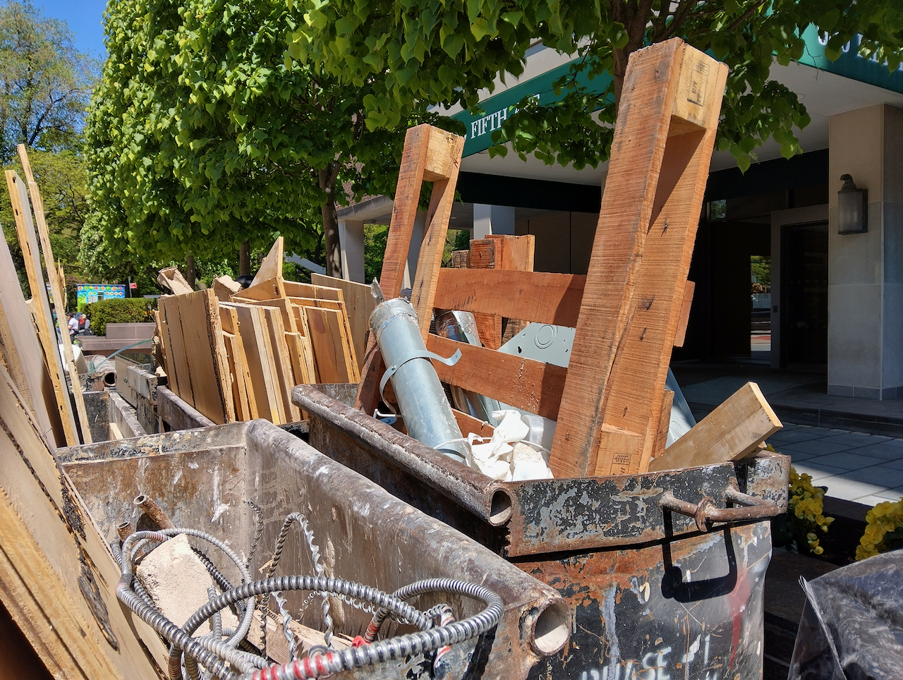 Wood piled into a dumpster. 