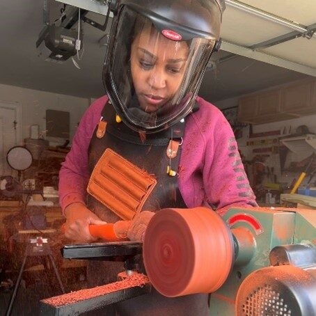 Char turns a padauk blank on a lathe.