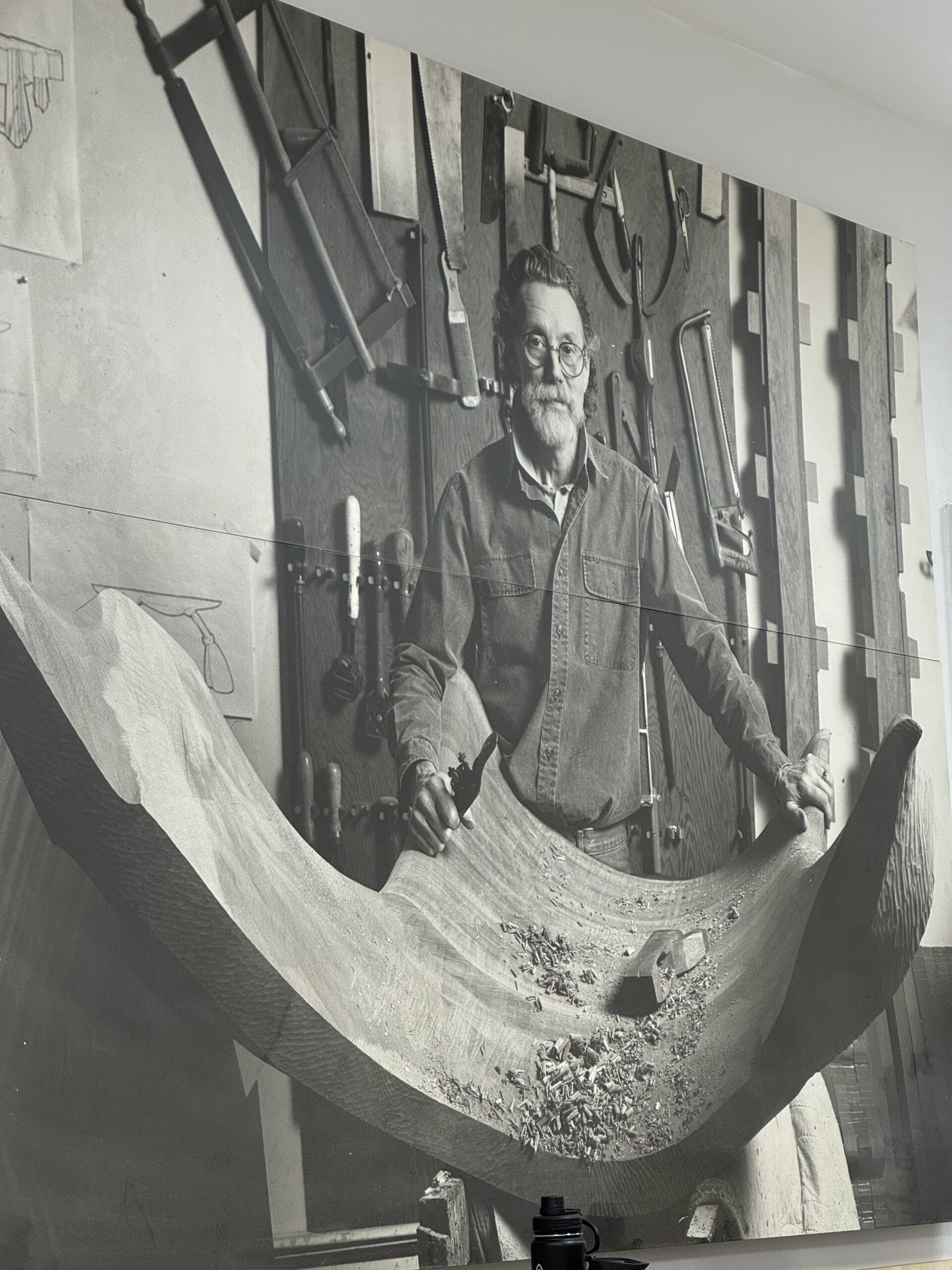 A large photo of Wendell Castle looming over the room.